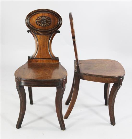 Pair of early 19th century mahogany hall chairs(-)